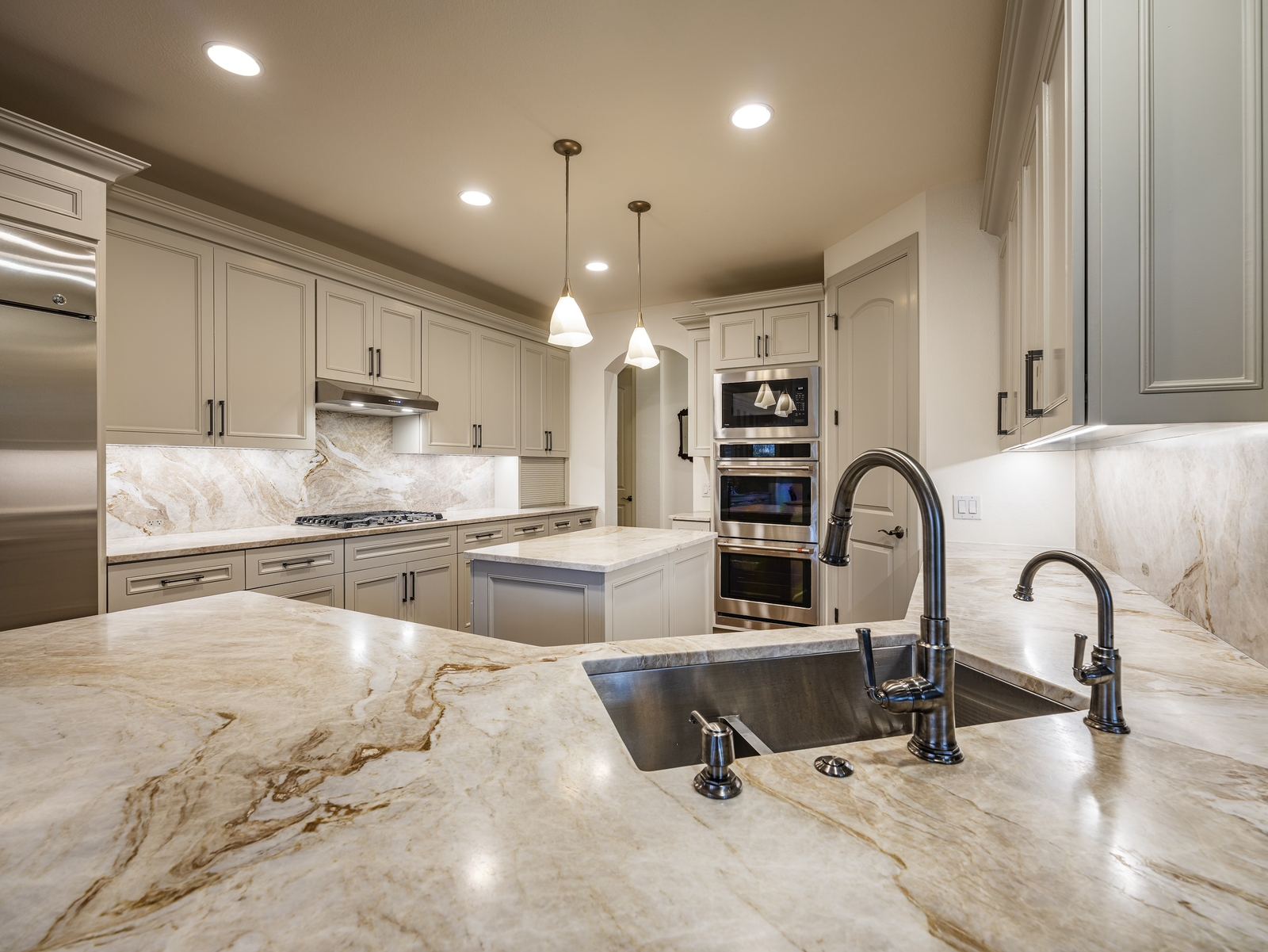 Remodeled kitchen with marble island and stainless appliances, private residence, Austin, TX