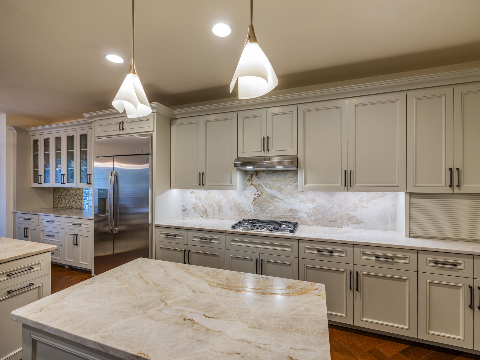 Remodeled kitchen with marble backsplash and pendant lighting, private residence, Austin, TX